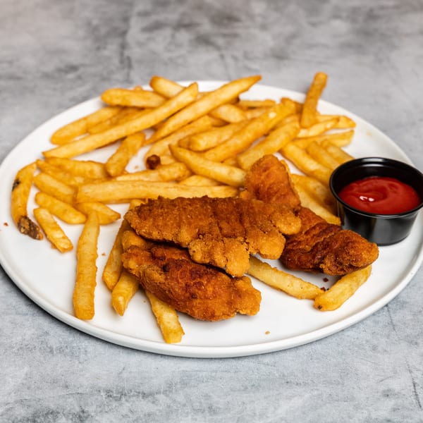 Fried chicken tenders and french fries with a side of ketchup on a white plate.