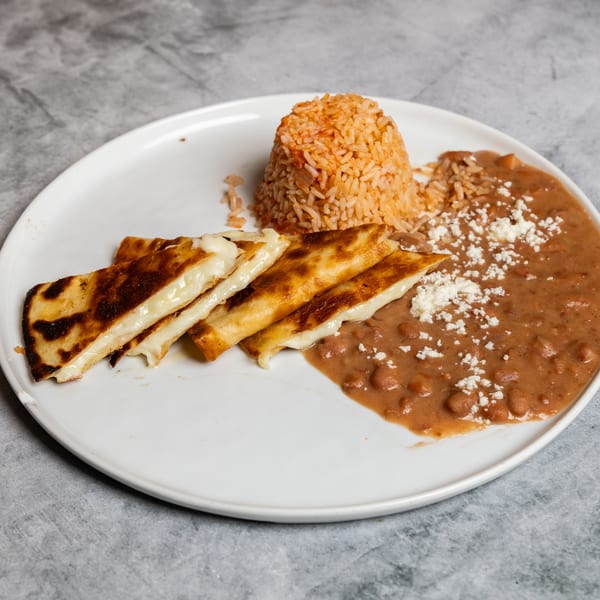 Plate with four golden cheese quesadillas, red rice, and refried beans with crumbled cheese.