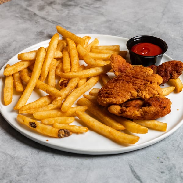 Crispy fried chicken tenders and golden french fries with a side of ketchup on a white plate.